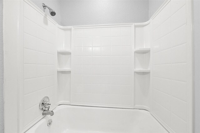 11423 Raincove Dr, Houston, TX 77016 - bathroom featuring shower / bath combination and a textured wall