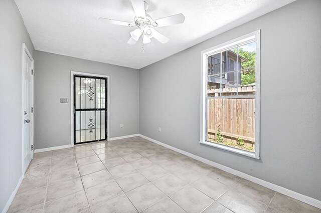 11423 Raincove Dr, Houston, TX 77016 - empty room with a ceiling fan, light tile patterned floors, and baseboards