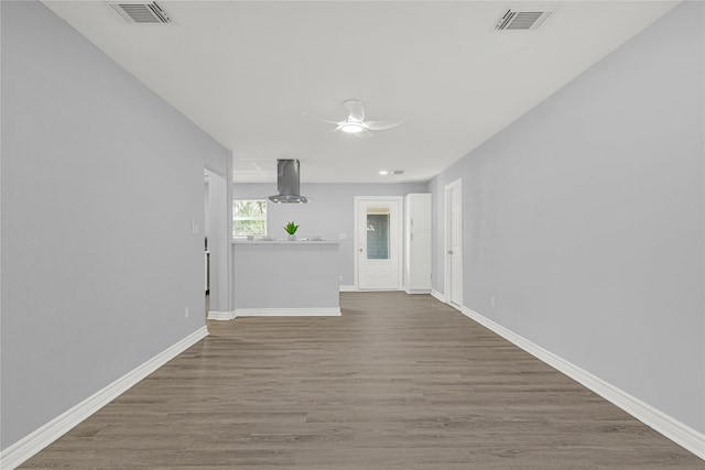 11423 Raincove Dr, Houston, TX 77016 - spare room with a ceiling fan, wood finished floors, and baseboards