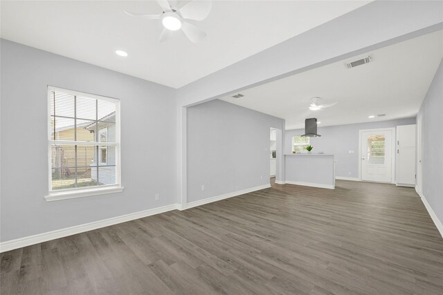 11423 Raincove Dr, Houston, TX 77016 - unfurnished living room with a ceiling fan, dark wood-type flooring, baseboards, and recessed lighting