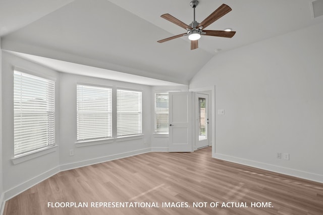 20614 Draper Rd, Tomball, TX 77377 - empty room with wood finished floors, lofted ceiling, healthy amount of natural light, a ceiling fan, and baseboards