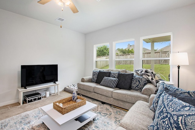 40557 Mostyn Lake Dr, Magnolia, TX 77354 - living area with a ceiling fan, carpet floors, and baseboards