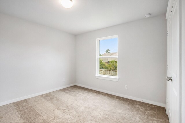 40557 Mostyn Lake Dr, Magnolia, TX 77354 - unfurnished room with carpet floors, baseboards, and a smoke detector
