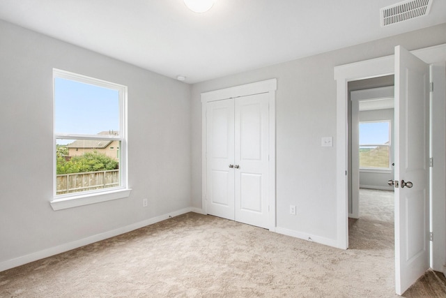 40557 Mostyn Lake Dr, Magnolia, TX 77354 - unfurnished bedroom featuring carpet, baseboards, and a closet
