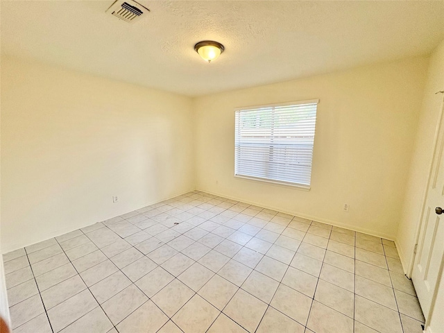 12803 Cloverwood Dr, Cypress, TX 77429 - spare room featuring light tile patterned flooring and a textured ceiling