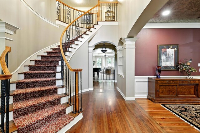 4503 Summits Edge Ln, Katy, TX 77494 - foyer featuring decorative columns, arched walkways, wood-type flooring, stairway, and a ceiling fan