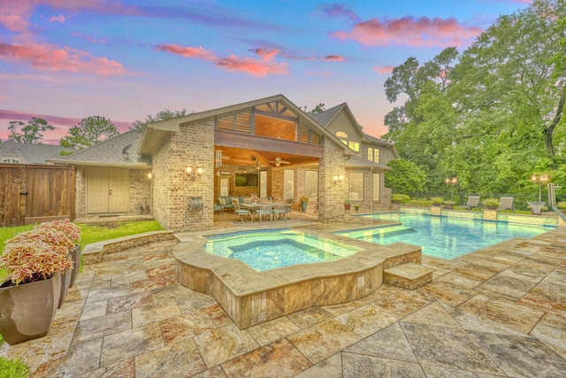 4503 Summits Edge Ln, Katy, TX 77494 - pool at dusk with ceiling fan, an in-ground hot tub, a patio, and an outdoor pool