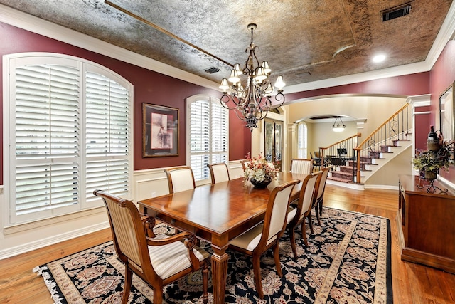 4503 Summits Edge Ln, Katy, TX 77494 - dining room with arched walkways, a chandelier, wood finished floors, stairway, and ornamental molding
