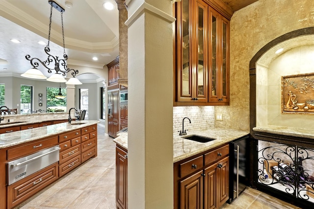 4503 Summits Edge Ln, Katy, TX 77494 - kitchen with a warming drawer, wine cooler, ornamental molding, light stone countertops, and decorative light fixtures