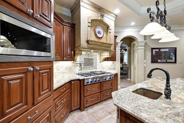 4503 Summits Edge Ln, Katy, TX 77494 - kitchen featuring stainless steel appliances, ornamental molding, ornate columns, decorative backsplash, and light stone counters