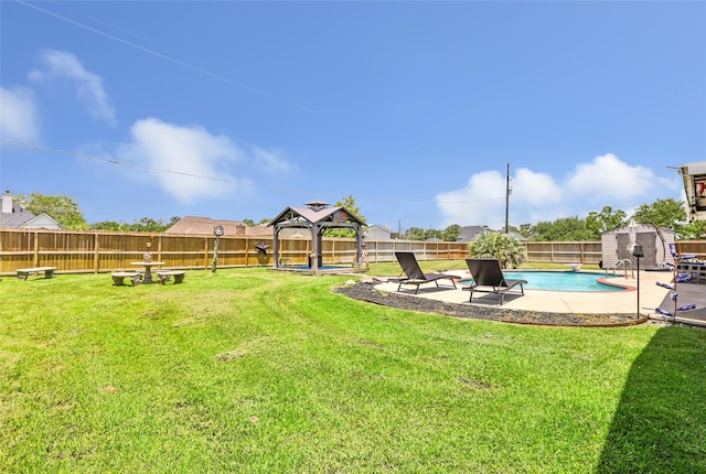 5810 Dixie Ln, Baytown, TX 77523 - fenced backyard featuring a gazebo, a storage unit, and a patio