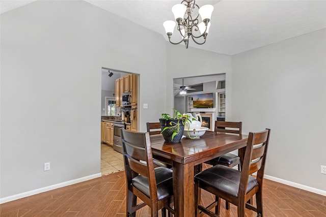 5810 Dixie Ln, Baytown, TX 77523 - dining room with vaulted ceiling, a lit fireplace, a chandelier, light wood-type flooring, and ceiling fan
