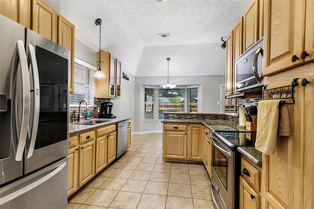 5810 Dixie Ln, Baytown, TX 77523 - kitchen with appliances with stainless steel finishes, light tile patterned floors, lofted ceiling, a chandelier, and a textured ceiling