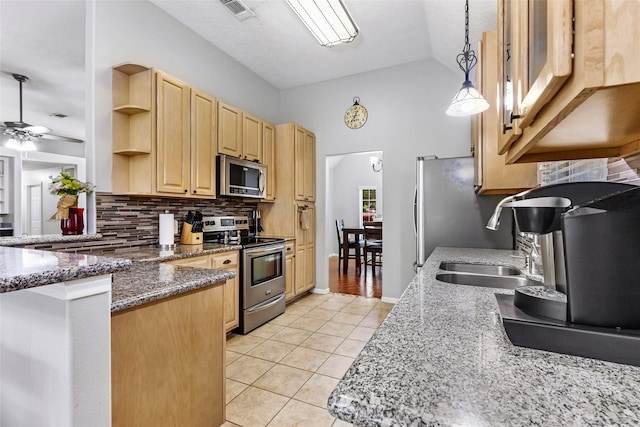 5810 Dixie Ln, Baytown, TX 77523 - kitchen with stainless steel appliances, light brown cabinets, light tile patterned flooring, backsplash, and a peninsula