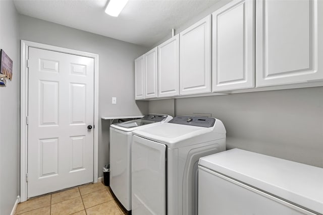 5810 Dixie Ln, Baytown, TX 77523 - washroom featuring cabinet space, independent washer and dryer, and light tile patterned flooring
