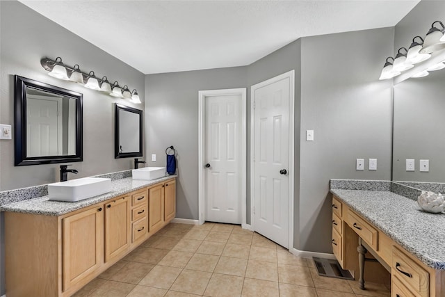 5810 Dixie Ln, Baytown, TX 77523 - bathroom with double vanity and tile patterned flooring
