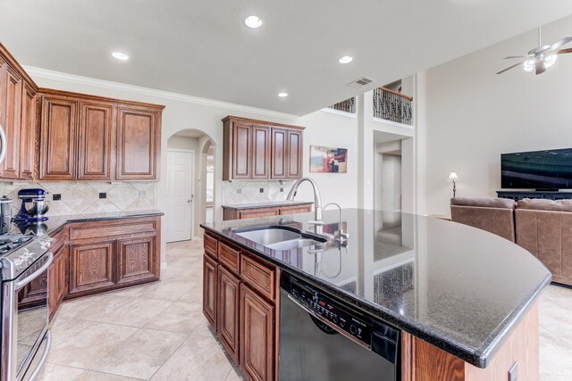 2215 Dali Ln, Missouri City, TX 77459 - kitchen with black dishwasher, a sink, stainless steel gas stove, arched walkways, and decorative backsplash