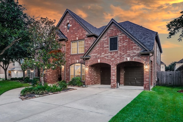 2215 Dali Ln, Missouri City, TX 77459 - view of front of home with brick siding, driveway, an attached garage, and a shingled roof