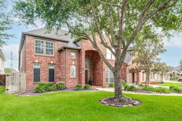 2215 Dali Ln, Missouri City, TX 77459 - traditional-style home featuring brick siding and roof with shingles