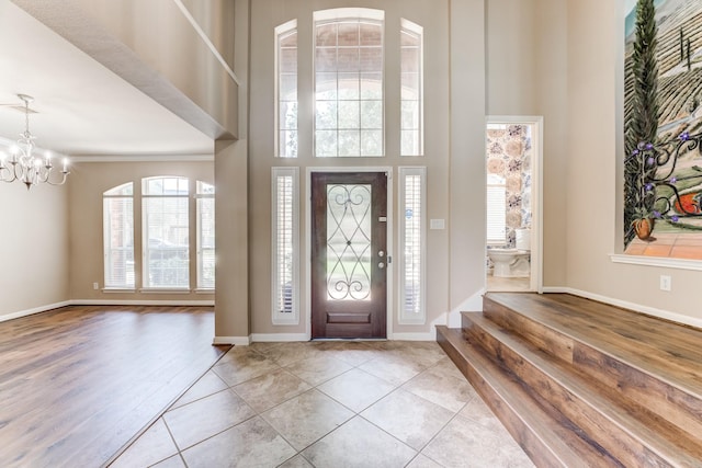 2215 Dali Ln, Missouri City, TX 77459 - tiled foyer with a chandelier, a high ceiling, and baseboards