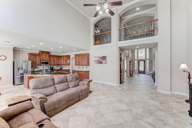 2215 Dali Ln, Missouri City, TX 77459 - living area with ceiling fan, crown molding, baseboards, a high ceiling, and recessed lighting
