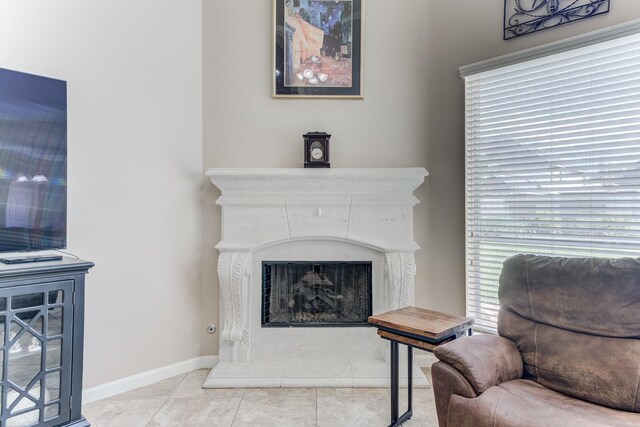 2215 Dali Ln, Missouri City, TX 77459 - sitting room featuring a fireplace with raised hearth, tile patterned flooring, and baseboards