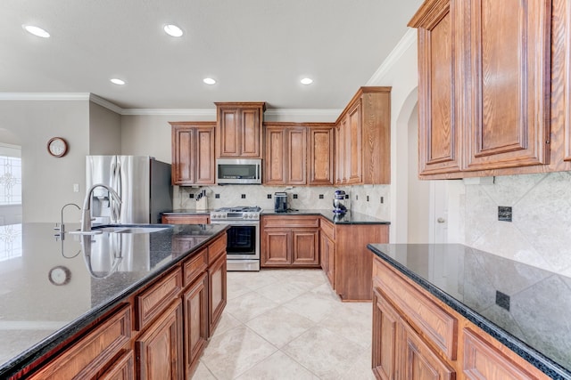 2215 Dali Ln, Missouri City, TX 77459 - kitchen featuring appliances with stainless steel finishes, arched walkways, a sink, crown molding, and backsplash