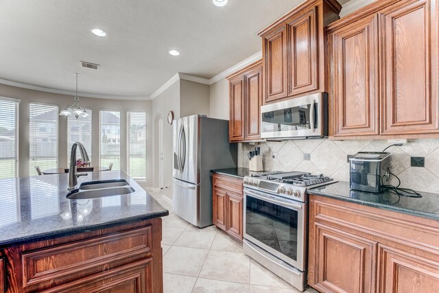 2215 Dali Ln, Missouri City, TX 77459 - kitchen with stainless steel appliances, a sink, tasteful backsplash, dark stone counters, and brown cabinets