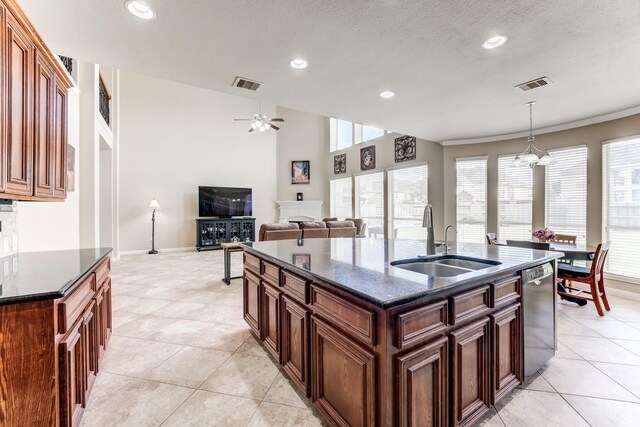 2215 Dali Ln, Missouri City, TX 77459 - kitchen with a sink, dishwasher, a ceiling fan, light tile patterned flooring, and a textured ceiling