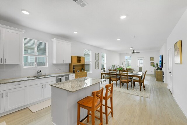 16910 Elm Grove Rd, Conroe, TX 77302 - kitchen featuring a sink, light wood-type flooring, decorative backsplash, white cabinets, and recessed lighting