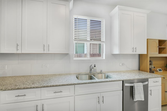 16910 Elm Grove Rd, Conroe, TX 77302 - kitchen with stainless steel dishwasher, a sink, white cabinets, and tasteful backsplash