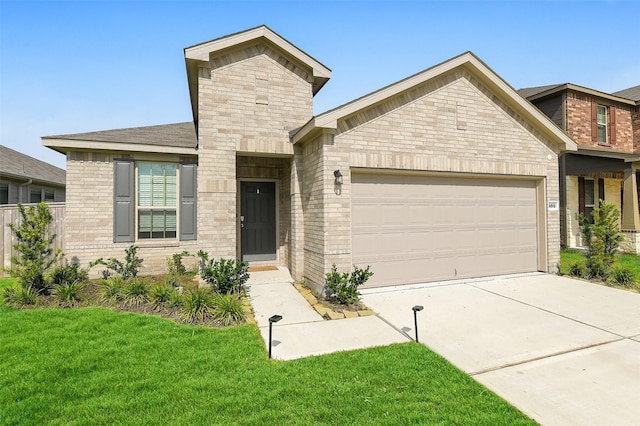 16910 Elm Grove Rd, Conroe, TX 77302 - view of front of house featuring an attached garage, a front yard, driveway, and brick siding