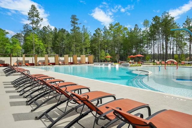 16910 Elm Grove Rd, Conroe, TX 77302 - community pool featuring a patio area and view of scattered trees