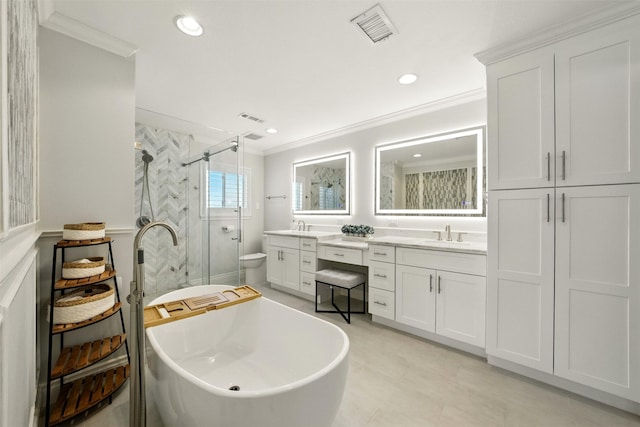 10718 Chevy Chase Dr, Houston, TX 77042 - bathroom featuring double vanity, a stall shower, crown molding, a freestanding bath, and recessed lighting