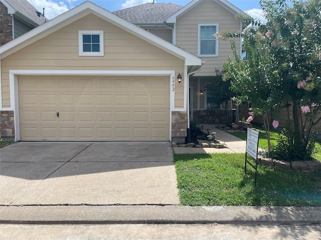 6442 Wilshire Lks, Houston, TX 77040 - view of front facade featuring concrete driveway, stone siding, and a garage