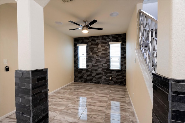 6442 Wilshire Lks, Houston, TX 77040 - empty room featuring a ceiling fan, arched walkways, and light marble finish flooring