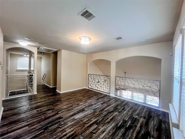 6442 Wilshire Lks, Houston, TX 77040 - empty room with wood finished floors, plenty of natural light, and arched walkways