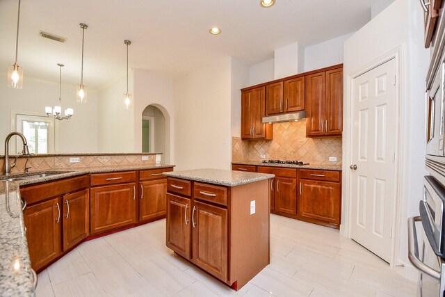 6402 Amelia Springs Dr, Spring, TX 77379 - kitchen featuring a sink, gas stovetop, decorative backsplash, arched walkways, and recessed lighting