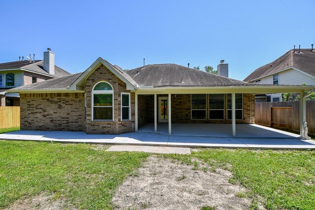 6402 Amelia Springs Dr, Spring, TX 77379 - back of property with brick siding, a patio area, a chimney, and roof with shingles