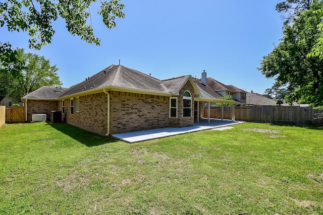 6402 Amelia Springs Dr, Spring, TX 77379 - back of house featuring a patio, central AC unit, brick siding, and a shingled roof