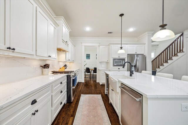 1136 Nadine St, Houston, TX 77009 - kitchen featuring stainless steel appliances, a sink, dark wood-type flooring, white cabinetry, and recessed lighting