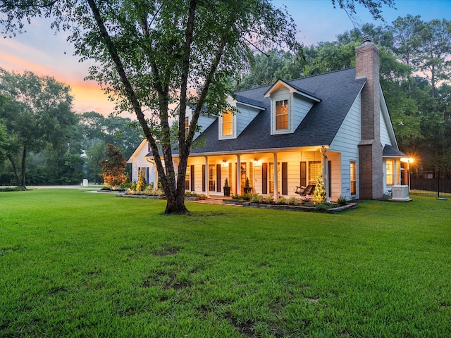 32363 Spinnaker Run, Magnolia, TX 77354 - back of property featuring central AC, a chimney, a lawn, and roof with shingles
