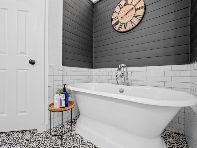 32363 Spinnaker Run, Magnolia, TX 77354 - bathroom with tile walls, a freestanding tub, and tile patterned floors