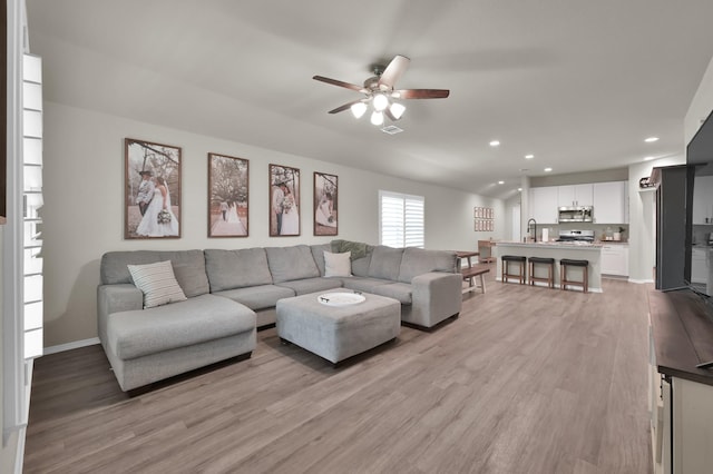 1887 Brushy Cedar Dr, Conroe, TX 77301 - living area featuring light wood-style floors, a ceiling fan, recessed lighting, and baseboards