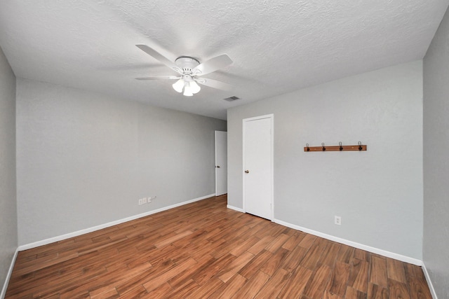 9422 Val Verde St, Houston, TX 77063 - empty room featuring wood finished floors, a ceiling fan, baseboards, and a textured ceiling