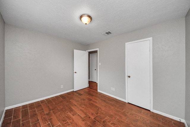 9422 Val Verde St, Houston, TX 77063 - unfurnished bedroom featuring wood finished floors, baseboards, and a textured ceiling