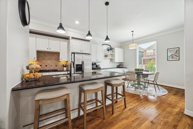 818 Garden Rose Ln, Houston, TX 77018 - kitchen with stainless steel fridge, open shelves, ornamental molding, white cabinetry, and tasteful backsplash
