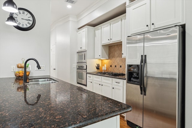 818 Garden Rose Ln, Houston, TX 77018 - kitchen with appliances with stainless steel finishes, white cabinetry, backsplash, dark stone counters, and decorative light fixtures
