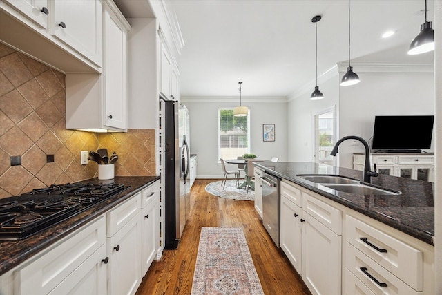 818 Garden Rose Ln, Houston, TX 77018 - kitchen with black gas cooktop, dishwasher, ornamental molding, wood finished floors, and white cabinetry