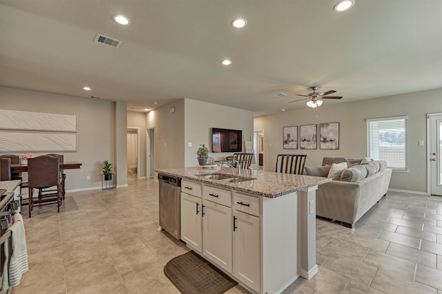13919 Leigh Lake Ln, Conroe, TX 77384 - kitchen featuring stainless steel dishwasher, light stone counters, recessed lighting, a center island with sink, and a ceiling fan